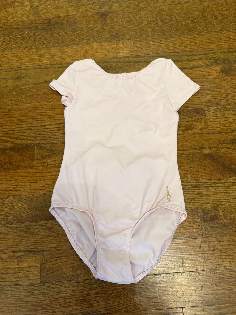 Justice Light Pink Short Sleeve Dance Leotard with Gold Script